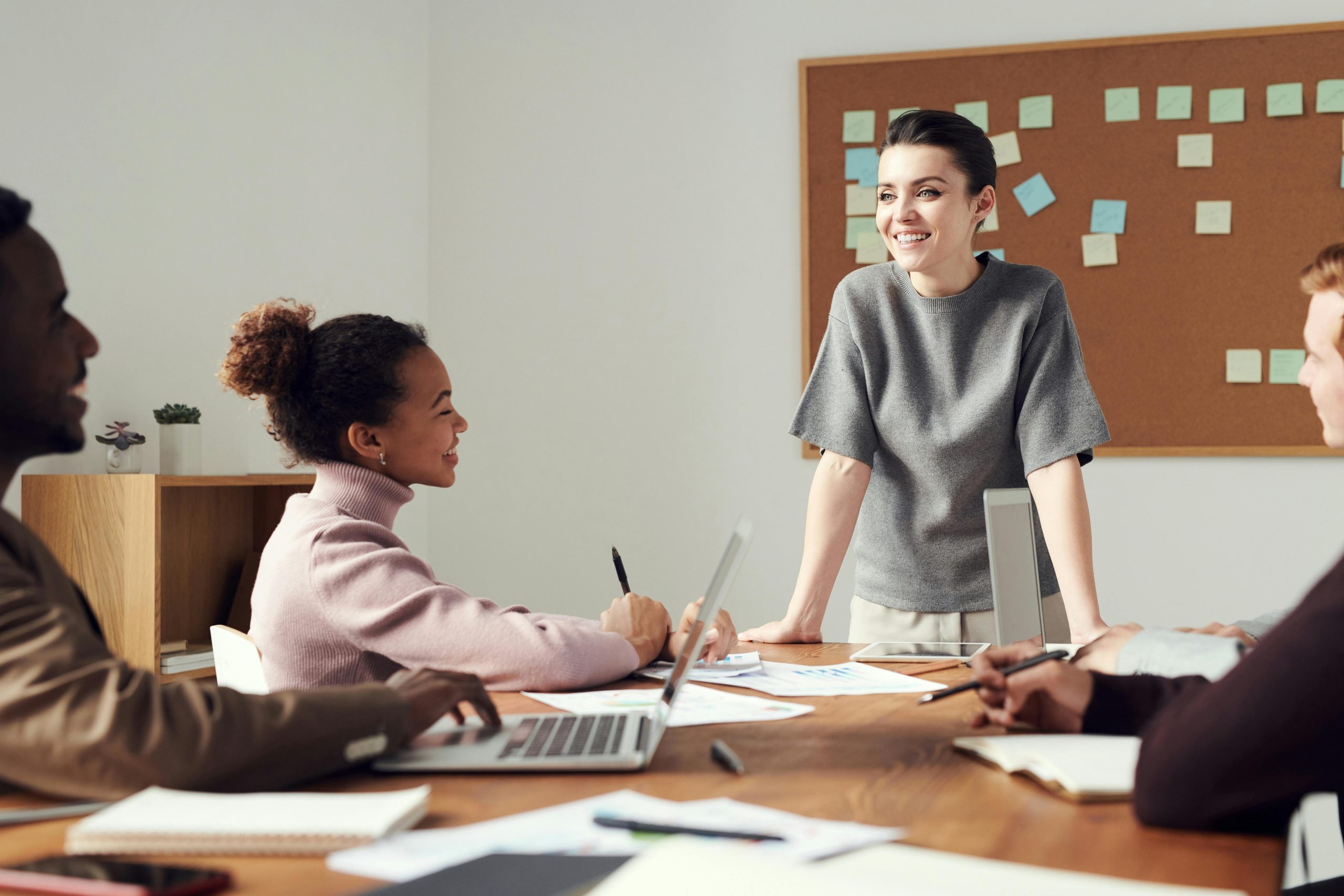 Team of peope in a workplace collaborating on a project together.